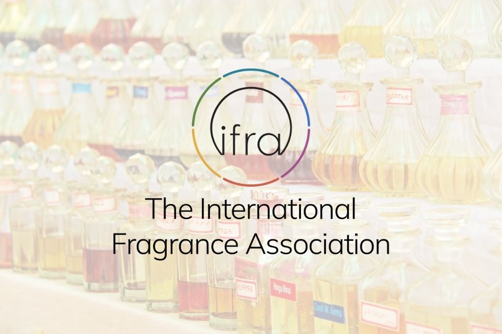IFRA logo with bottles of fragrance oils in the background